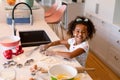 Happy african american messy girl baking in kitchen