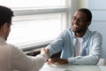 Happy african american job applicant shaking hands with hr manager. Royalty Free Stock Photo