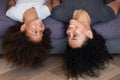 Happy African American mom and kid lying upside down Royalty Free Stock Photo