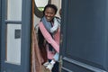 Happy african american mother with daughter in arms standing and smiling in doorway, copy space