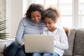 Happy African American mother and daughter using laptop Royalty Free Stock Photo