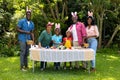 Happy african american multigenerational family in bunny ears with easter eggs in backyard Royalty Free Stock Photo