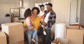 Happy African American parents with their children and boxes moving in new house Royalty Free Stock Photo