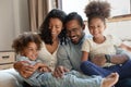 Happy African American parents and two excited kids having fun Royalty Free Stock Photo