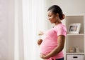 Happy african american pregnant woman with flower Royalty Free Stock Photo