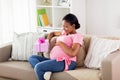 Happy african american pregnant woman with gift Royalty Free Stock Photo