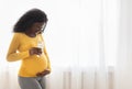 Happy african american pregnant woman holding glass of milk Royalty Free Stock Photo