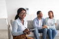 Happy African American psychologist and hugging married couple at office after successful therapy, copy space Royalty Free Stock Photo