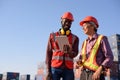 Happy African American and senior asian male worker using tablet during video call in a logistic shipping cargo containers yard Royalty Free Stock Photo
