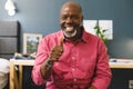 Happy african american senior man making video call smiling and giving thumb up sign to camera Royalty Free Stock Photo