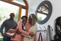 Happy african american senior mother welcoming adult daughter with husband at front door Royalty Free Stock Photo