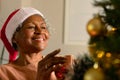 Happy african american senior woman decorating christmas tree Royalty Free Stock Photo