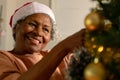 Happy african american senior woman decorating christmas tree Royalty Free Stock Photo