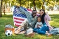 happy african american soldier in military uniform and family holding american flag