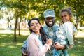 happy african american soldier in military uniform looking at camera with family