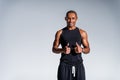 happy african american sportsman showing thumbs up and smiling at camera