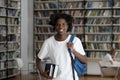 Happy African American student guy with dreads in college library Royalty Free Stock Photo
