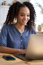 Happy African American teen girl student taking online class on laptop at home. Royalty Free Stock Photo