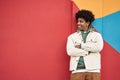 Happy African American teen guy looking away at colorful wall background. Royalty Free Stock Photo