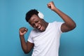 Happy african american teen listening to music with headphones