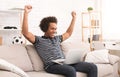 Happy african-american teenager celebrating win on laptop Royalty Free Stock Photo