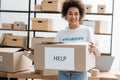 happy african american volunteer holding carton Royalty Free Stock Photo