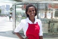 Happy african american waitress in front of the restaurant Royalty Free Stock Photo