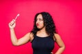 Happy African American woman brushes teeth. Dental hygiene concept. Isolated on red background.