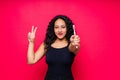 Happy African American woman brushes teeth. Dental hygiene concept. Isolated on red background.