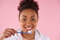 Happy African American woman brushes teeth.