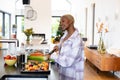 Happy african american woman cooking in kitchen, chopping vegetables Royalty Free Stock Photo