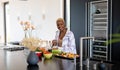 Happy african american woman cooking in kitchen, chopping vegetables Royalty Free Stock Photo