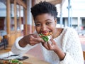 Happy african american woman eating pizza Royalty Free Stock Photo