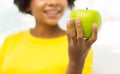 Happy african american woman with green apple Royalty Free Stock Photo