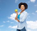 Happy african american woman with green apple Royalty Free Stock Photo