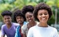 Happy african american woman with group of young adults in line Royalty Free Stock Photo