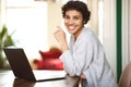 Happy african american woman with laptop computer at home Royalty Free Stock Photo