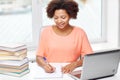 Happy african american woman with laptop at home Royalty Free Stock Photo