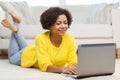 Happy african american woman with laptop at home Royalty Free Stock Photo