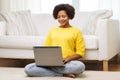 Happy african american woman with laptop at home Royalty Free Stock Photo