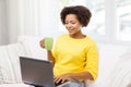 Happy african american woman with laptop at home Royalty Free Stock Photo