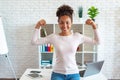 Happy african american woman make a gesture showing biceps as an athlete Royalty Free Stock Photo