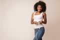 Happy african-american woman measuring waist with tape Royalty Free Stock Photo