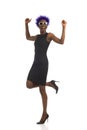 Happy African American Woman In Mini Dress And High Heels Is Standing On One Leg And Cheering Royalty Free Stock Photo
