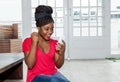 Happy african american woman receiving good news on phone Royalty Free Stock Photo