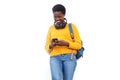 Happy african american woman smiling against white background with smart phone and bag Royalty Free Stock Photo