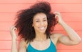 Happy african american woman smiling with hand in hair Royalty Free Stock Photo