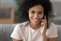 Happy african american woman talking on mobile phone at home Royalty Free Stock Photo