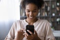 Happy African American woman use cellphone text online
