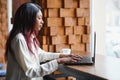 Happy african american woman worker using laptop work study at computer in loft office or cafe, smiling mixed race female student Royalty Free Stock Photo